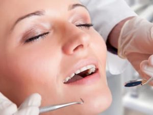 A woman in a carefree state during her dentist visit, as though she is under conscious sedation.